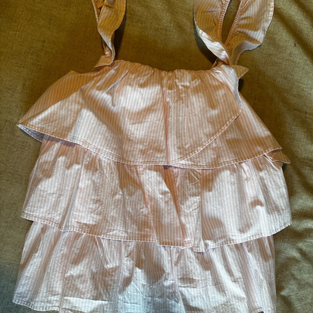Very flattering white and pink pin stripe top with tiered ruffle detailing.